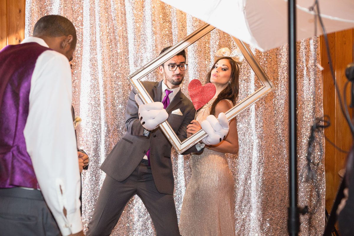 Having a blast in the photo booth at the Estate on the Halifax by Orlando wedding photographer