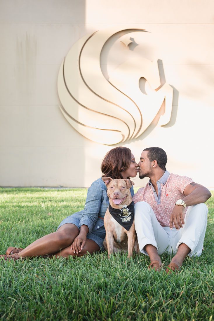 Top Orlando wedding photographer captures fun engagement session featuring a pitbull dog and a beautiful couple at UCF in Orlando