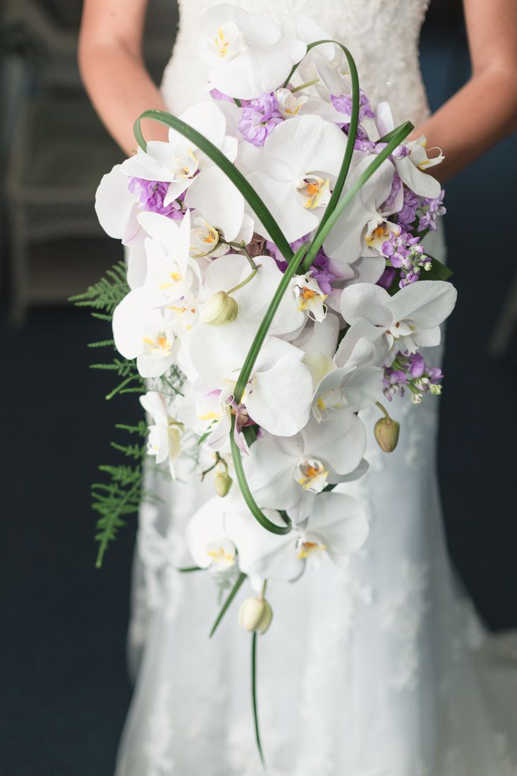 Cascading orchid bouquet for a lighthouse and yacht club wedding by Orlando wedding photographer