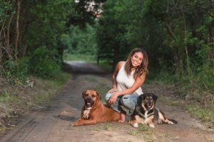 Adorable family photos in the woods with two dogs captured by top Orlando wedding and portrait photographer