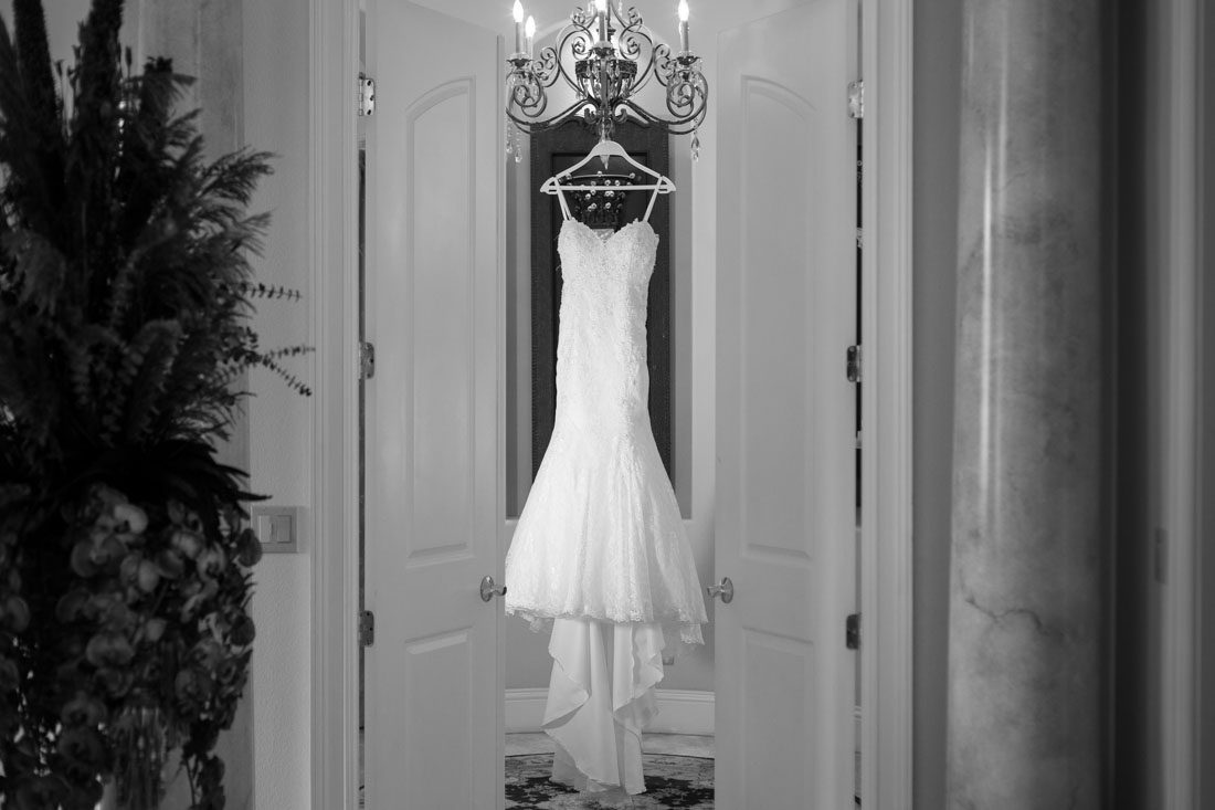 Brides dress hanging captured by top Orlando wedding photographer and videographer
