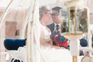 Romantic Disney wedding in Orlando featuring Cinderella's coach and a beauty and the best theme captured by top Orlando wedding photographer and videographer