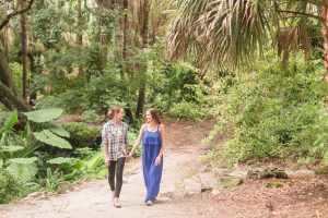 Romantic park LGBT engagement photography session with their adorable puppy dog by top Orlando wedding photographer