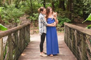 Romantic park LGBT engagement photography session with their adorable puppy dog by top Orlando wedding photographer