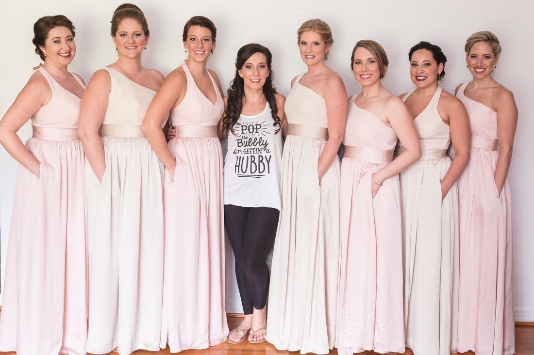 Bridesmaids in champagne and blush dresses get ready for Veranda at Thornton park wedding by Orlando wedding photographer and videographer