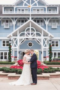 Couples poses for portrait in front of the Disney yacht and beach club for Orlando wedding photographer