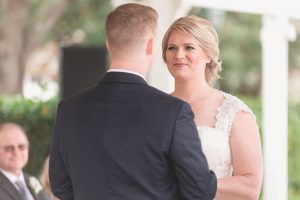 Couple exchanging wedding vows at Sea Breeze point wedding ceremony at Disney by top Orlando photographer and videographer