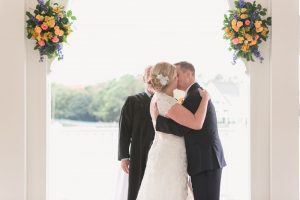 First kiss at Sea Breeze point boardwalk wedding at Disney by Orlando wedding photographer