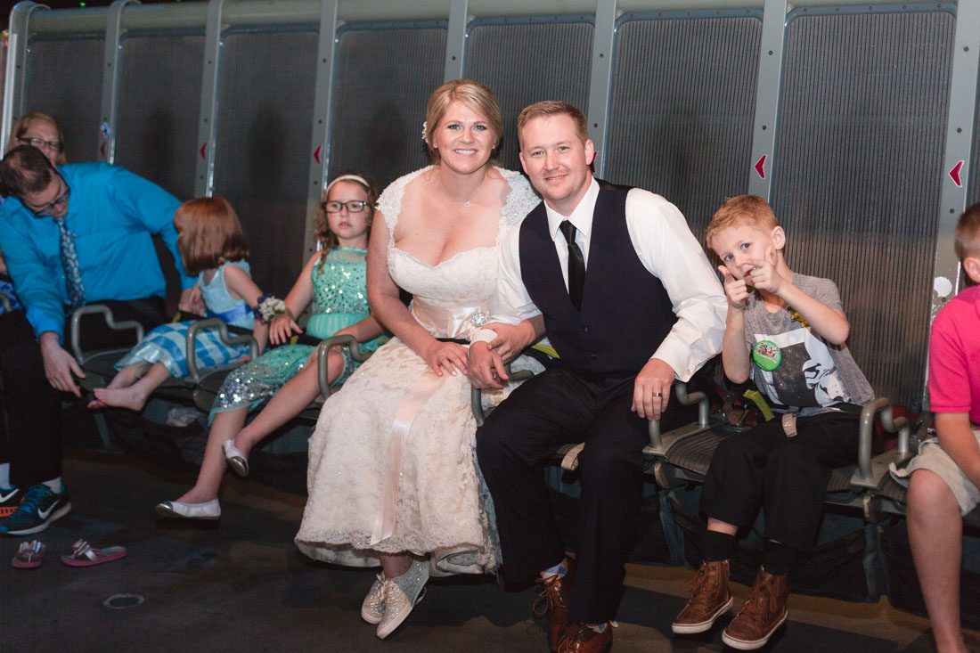 Newlywed couple rides Epcot's Soarin ride during their wedding reception captured by top Disney wedding photographer