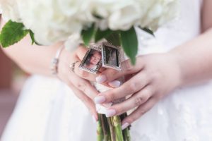 Close up of the brides bouquet charms on her white bouquet for her Disney wedding