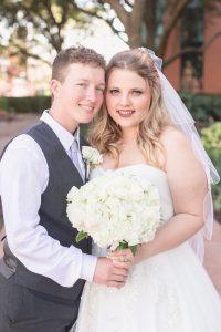 Same sex couple poses with the wedding bouquet at their Disney wedding captured by top Orlando photographer