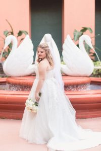 Bride poses in front of the swan statues at Disney's swan and dolphin resort wedding