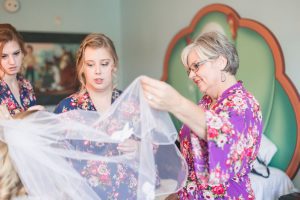 Lesbian bride and bridesmaids get ready at Disney's Art of Animation resort in preparation for their wedding day with top Orlando photographer
