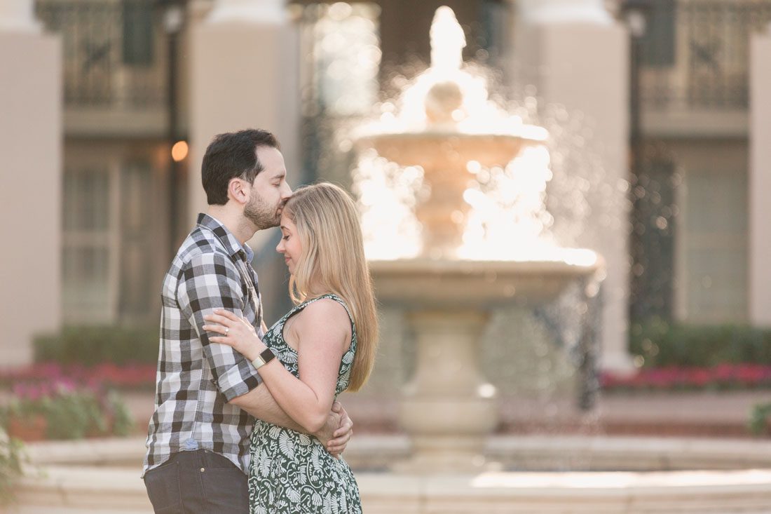 Romantic engagement photo in front of a glowing fountain at Disney Port Orleans Riverside resort captured by top Orlando photographer