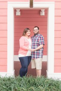 Couple posing for engagement photos by top Orlando photographer at Disney Boardwalk