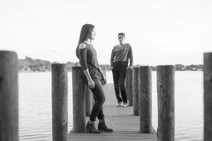 Engaged couple of a dock at the lake at Rollins college in Winter Park captured by Orlando wedding photographer