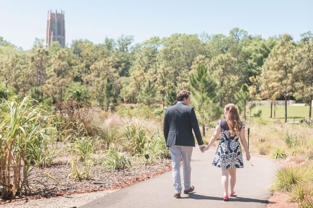 Walking through Bok Tower botanical gardens during their engagement photography shoot with Orlando photographer