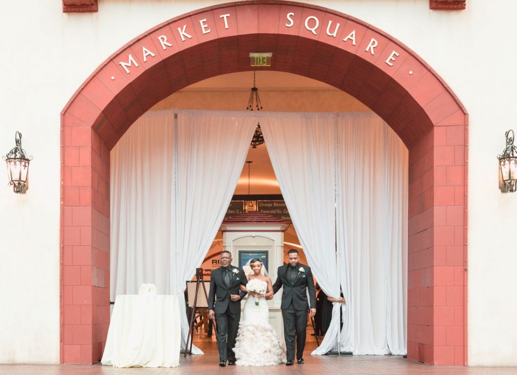 Bride entering her wedding ceremony at the Gaylord Palms atrium in Orlando, Florida