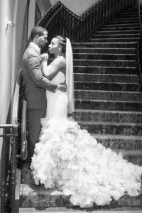Bride and groom pose on the stairs at the Gaylord Palms