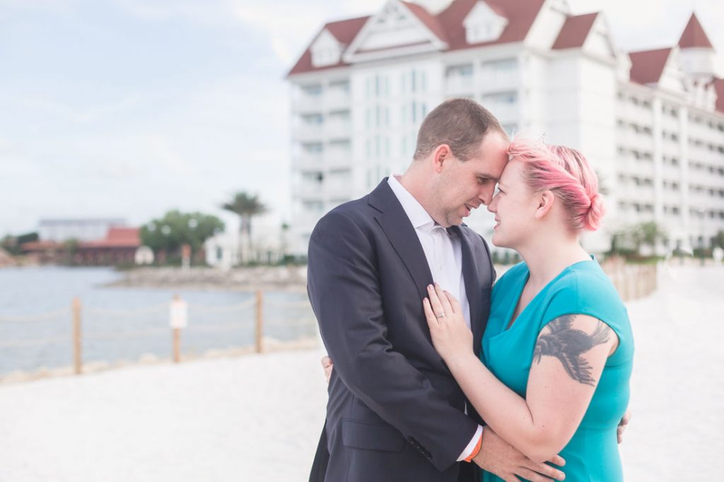 Newly engaged couple poses for engagement photo following a surprise proposal at Disney's Grand Floridian in Orlando