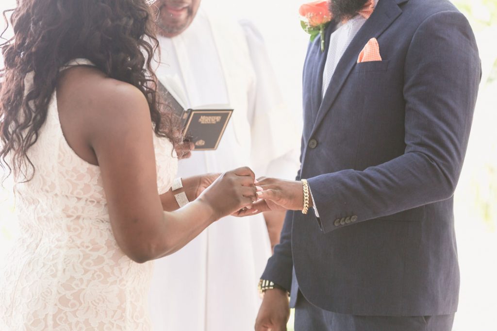 Couple exchanges wedding rings at Kraft Azalea garden elopement in Winter Park captured by Orlando wedding photographer