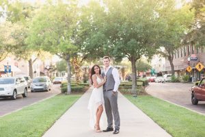 Engagement photos along a tree lined street in the charming historic town of Winter Garden, Florida captured by top Orlando wedding photographer