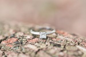 Engagement ring close up on a tree at Kraft Azalea gardens during this romantic Winter Park engagement shoot