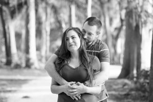 Romantic black and white engagement photo taken by top Orlando wedding photographer at Kraft Azalea gardens by the water