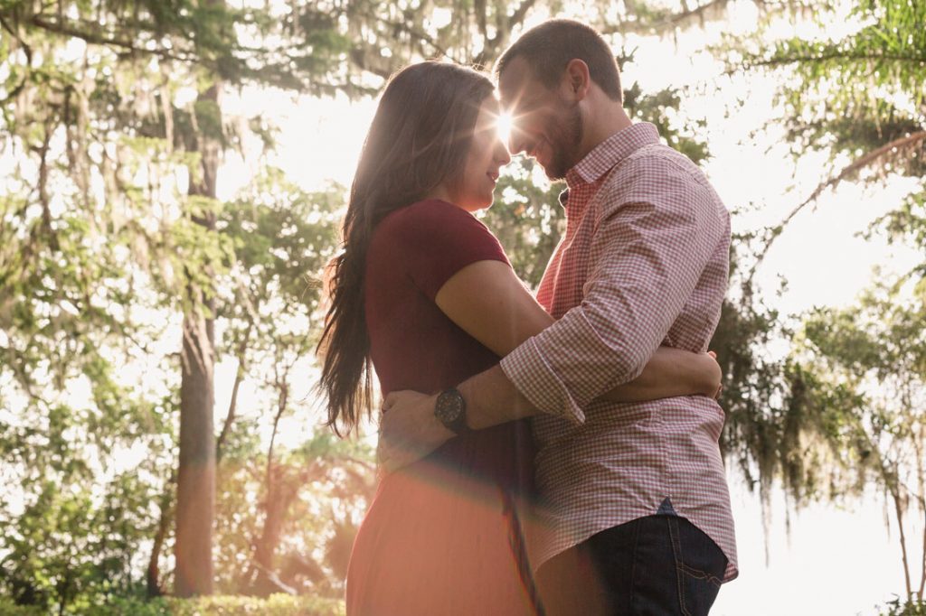 Sweet sunset engagement photography session with top Orlando wedding photographer and videographer at a garden in Winter Park