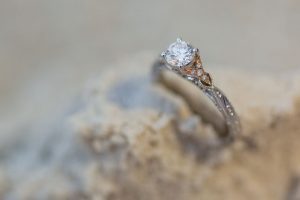 Close up of the engagement ring in the sand at the Polynesian Resort at Disney captured by top Orlando wedding and engagement photographer