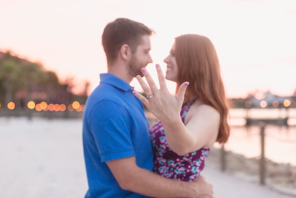 Bride to be showing off her engagement ring during a sunset photo shoot at Disney Polynesian resort captured by top Orlando photographer