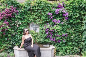 Posing in front of a lush wall of greenery at a garden in Montreal Canada during my travels