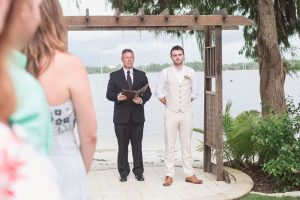 Groom sees the bride for the first time down the aisle at Paradise Cove in Orlando Florida