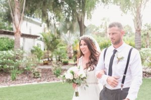 Orlando wedding photographer captures the Bride beaming as she sees her groom down the aisle