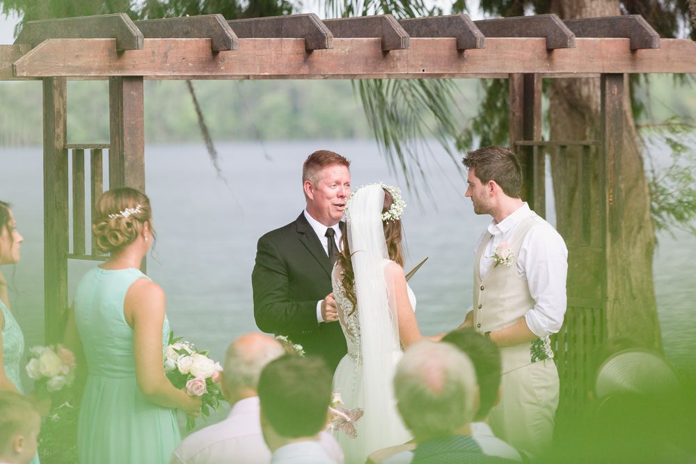 Bride and groom exchange vows at Paradise Cove Orlando wedding captured by top photography and videography team in Central Florida
