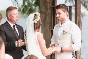 Bride and groom exchange vows at Paradise Cove Orlando wedding captured by top photography and videography team in Central Florida