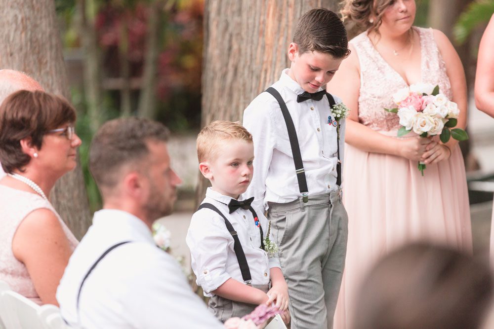 Ring bearers look on during this romantic beachy ceremony at Paradise Cove in Central Florida