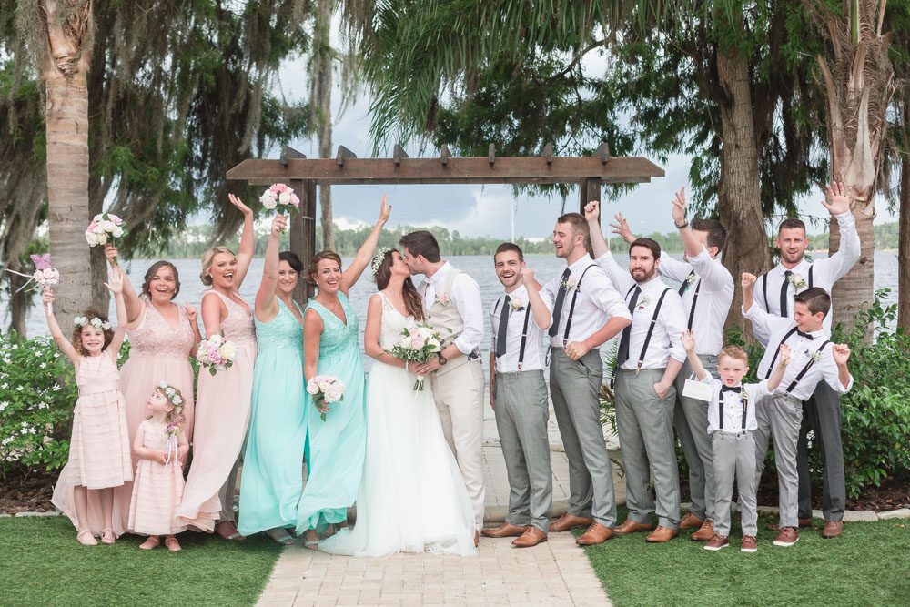 Bridal party cheering on bride and groom at Paradise Cove at top wedding venue in Orlando, Florida