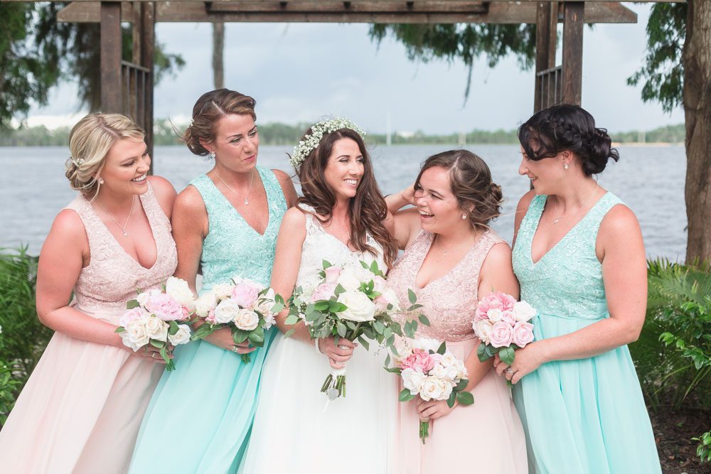 Bridal party laughing with the bride at Paradise Cove at top wedding venue in Orlando, Florida