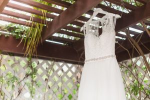 Bride's wedding dress hanging outside her suite at Paradise Cove for her Orlando wedding
