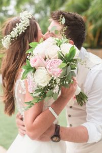 Orlando wedding photographer captures bride holding her beautiful blush pink and cream bouquet at Paradise Cove