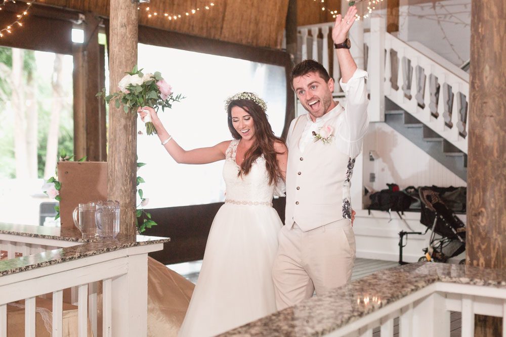 Newlyweds make their entrance into their paradise cove wedding at Orlando Florida