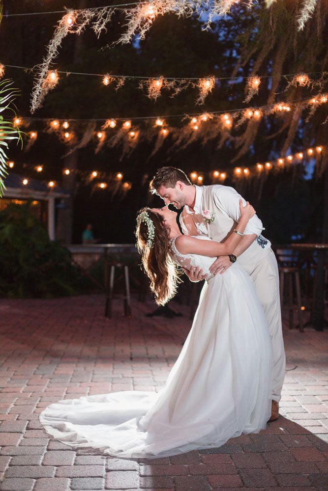 Gorgeous nighttime portraits of the bride and groom at Paradise Cove captured by top Orlando wedding photographer