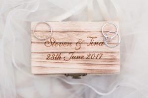 Wooden ring box featuring the couples wedding bands for their Paradise Cove Orlando wedding day
