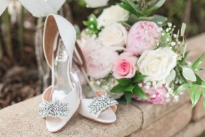 Close up of the bridal bouquet and shoes captured by top Orlando wedding photographer and videographer