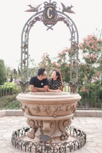Married couple in front of the fountain at Cinderella's castle at Disney world during their anniversary photo shoot with top Central Florida photographer