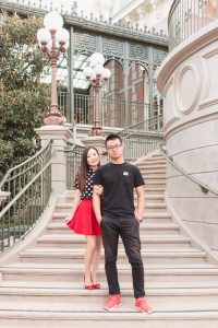 Couple posing on the stairs at Magic Kingdom park in Disney World for their sweet anniversary photo shoot with one of the top photographers in Orlando