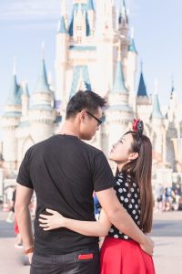 Anniversary photo shoot in front of the Cinderella castle in Orlando during the couples vacation to Central Florida