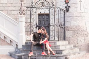 Fun and playful photography session at Walt Disney World castle in the theme park captured by top Orlando wedding and engagement photographer