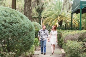Engaged couple walking along the sidewalk during their beautiful photo shoot in Winter Park with one of the best wedding photographers in Orlando